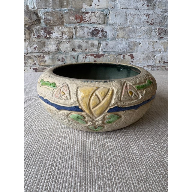 Striking vintage art pottery bowl featuring an embossed foliate motif with rich textural relief and hand-applied color...