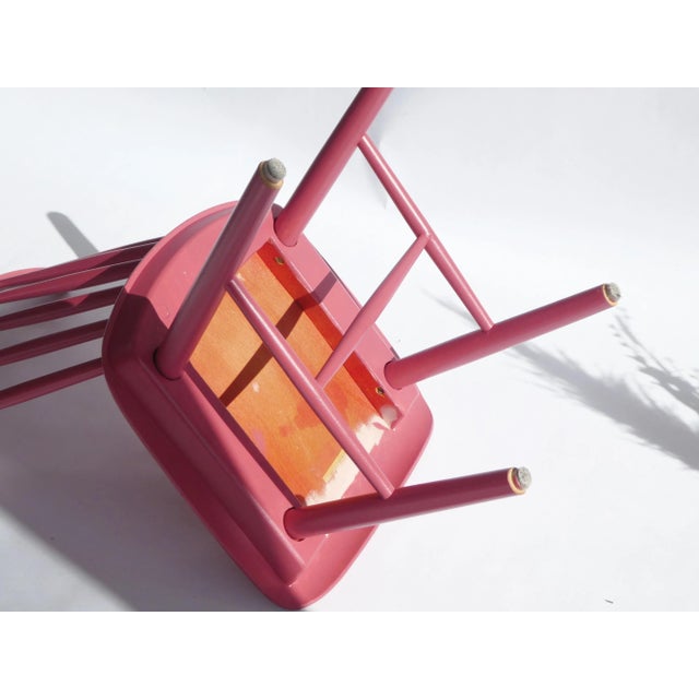 Wooden mid century swindle chair painted in pink/fuchsia and made in Czechoslovakia with a sticker of origin on the...