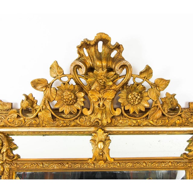 This is a magnificent antique French Louis Revival giltwood overmantle mirror, circa 1860 in date. The bevelled...