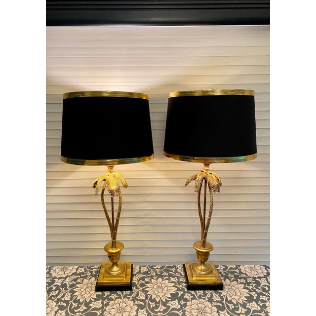 Spectacular pair of heavy brass lamps on black bases. Graceful double trunk palm trees. Three way switches. So much detail...
