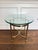 A sophisticated vintage brass and beveled glass side table executed in the iconic style of LaBarge, featuring a sculptural...