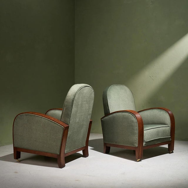 A pair of 1930s Art Deco lounge chairs upholstered in sage fabric, featuring Grissinato detailing on the arms with evenly...