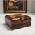 A compact mid-century box crafted from cocobolo and mixed hardwood inlays, perfect as a decorative accent or functional...