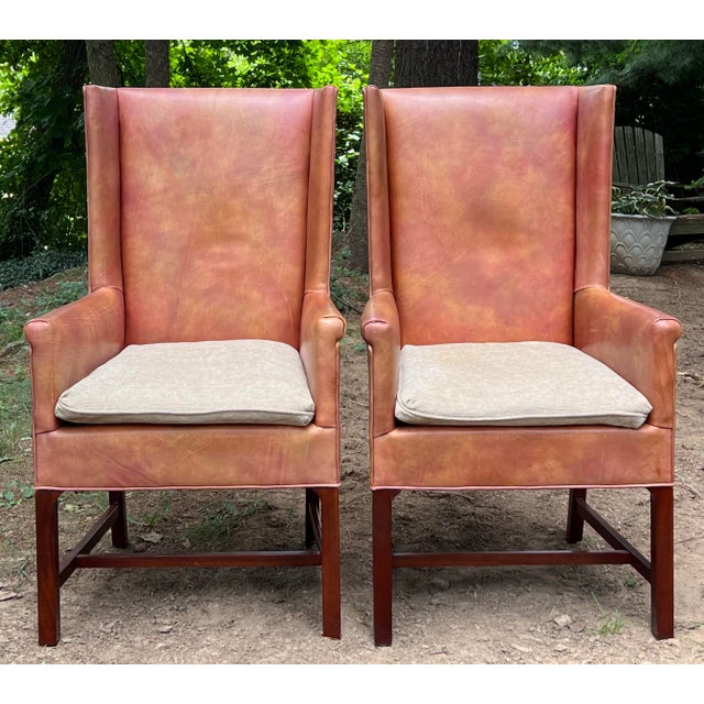 Great pair of Delaware Host Chairs by Hickory chair. Finished in a sumptuous distressed apricot toned leather with natural...