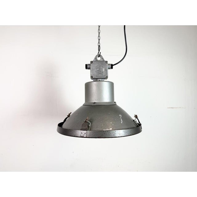 Industrial lamp made by Elektrosvit in former Czechoslovakia during the 1960s It features a grey hammer paint metal body,...