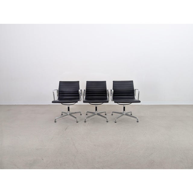 We are offering one of three beautiful Vitra EA 108 chairs with black leather upholstery for sale. Designed by Charles and...