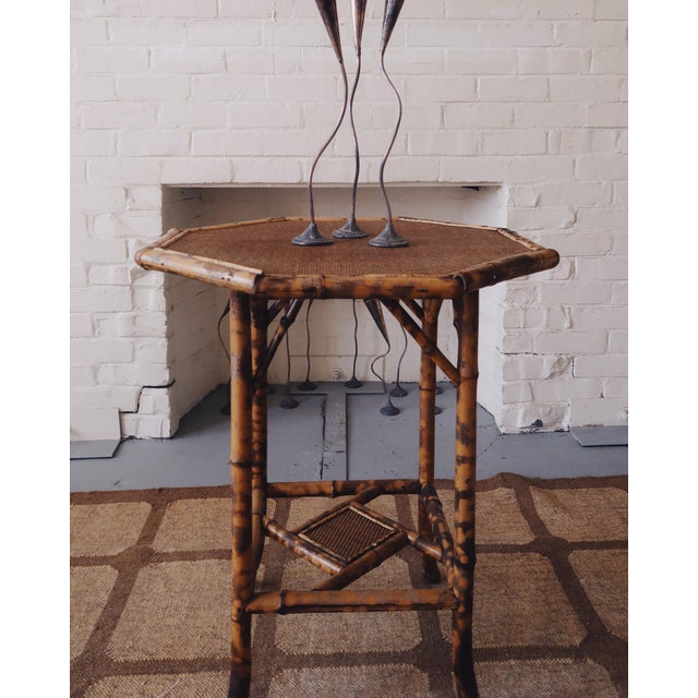 A 19th century Aesthetic Movement bamboo lamp table featuring an octagonal woven top supported by a geometric bamboo...