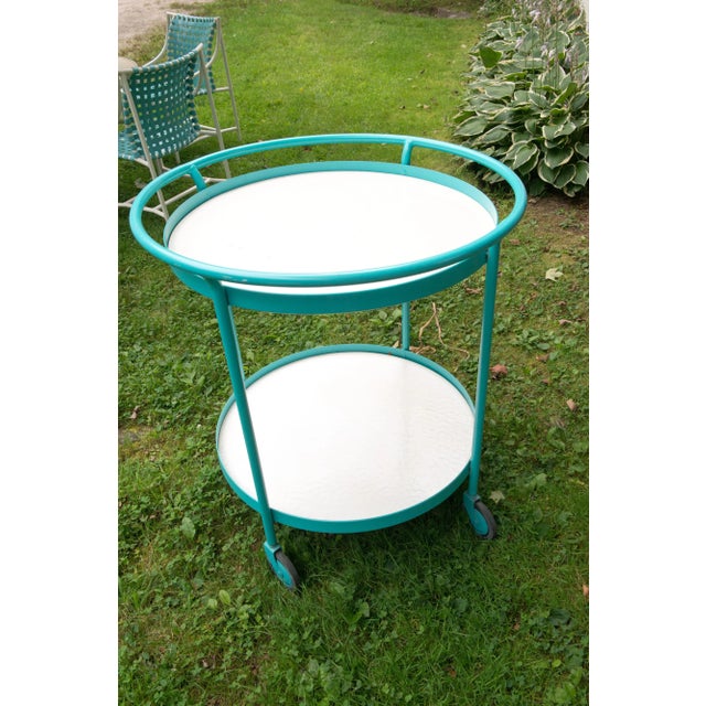 1960s Tropitone turquoise powdered coated aluminum round cart with two white laminate surfaces. Other separately priced...