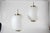 Set of two large China pendents made of off-white opaline glass and with brass fittings. The pendants are designed by...