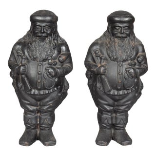 St Nicholas Cast Iron Andirons - a Pair For Sale