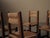 set of four chairs, crafted in France around 1960, features a strong geometric structure in solid oak. The square-section...