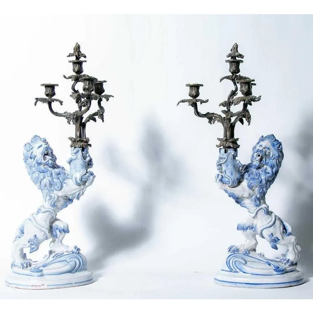 Pair of signed Emile Galle (French, 1846-1904) rampant lion faience candleholders Heraldic lion holding a castle tower in...