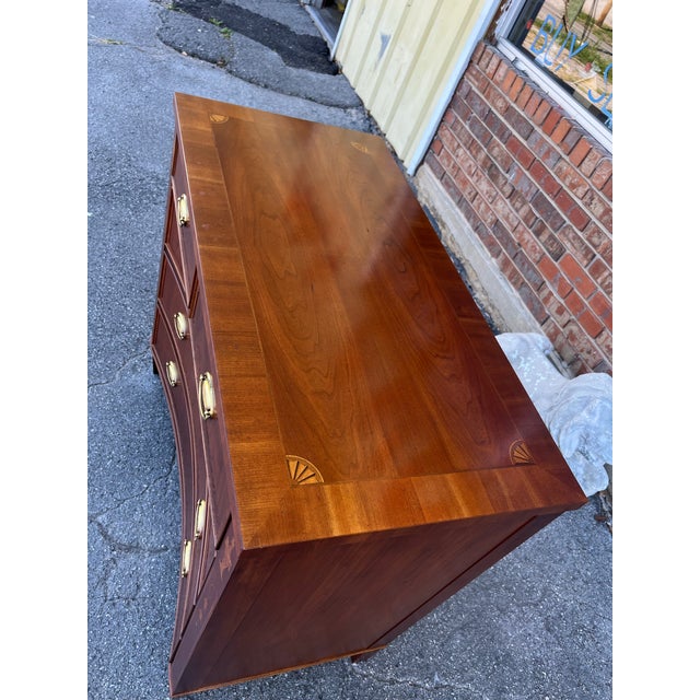 Very unique bachelor's chest by Hekman featuring a concave bowed design. The top is banded with four bookmatched panels in...