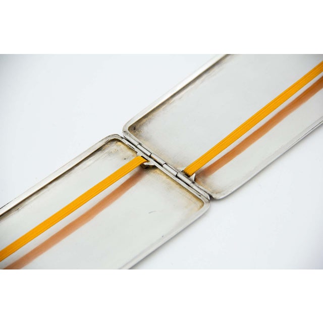 Rectangular Silver Cigarette Case with Hinged Lid, in Very Good conditions. Designed 1890 to 1919 This piece has an...