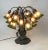 Vintage Tiffany Style Bronze Lily Flowers 18 Shade Georges Table Lamp. 21” tall by 20” wide. Base is Bronze Shades are...