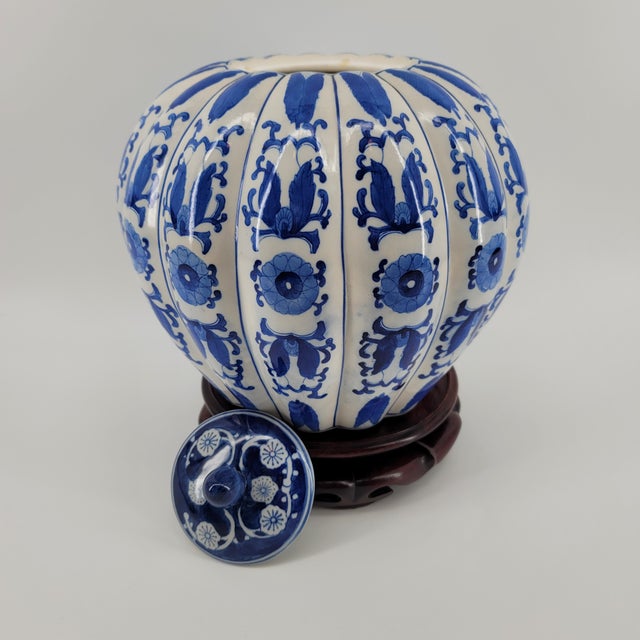 Elevate your interior with this exquisite vintage blue and white porcelain ginger jar. Featuring a classic "melon" ribbed...