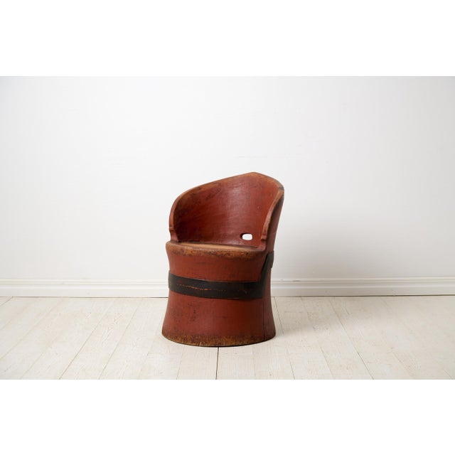 Antique Swedish stump chair with original red paint. The chair is a primitive furniture made by hand from one large, solid...