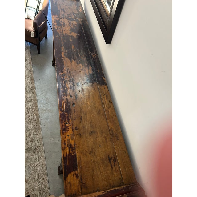 Warmth exudes from the patina centuries in the creation, this alter (console) table imported by Far Eastern Arts &...