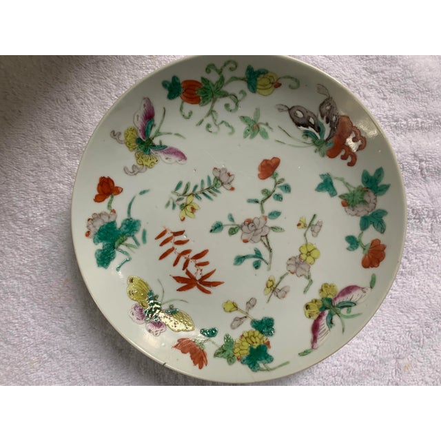 A hand-painted Chinese Famille rose dish from the Qing Dynasty (1862-1874, Tongzhi Period). The dish is meticulously hand...