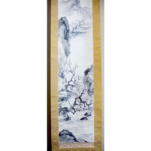 Chinese landscape scroll, signed with two red seal marks. Ink on paper mounted on an ornate, floral lattice, pattern...