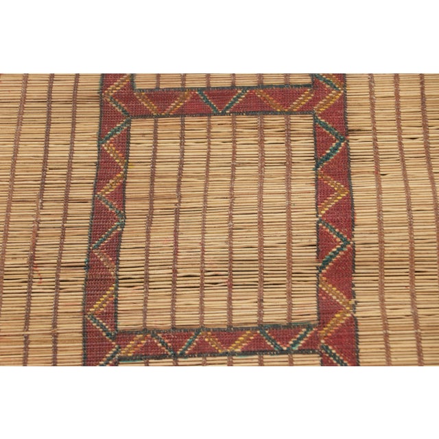Made with handwoven reed and camel leather in Mauritania circa 1950-1960, this 4x4 vintage square Tuareg mat is an...