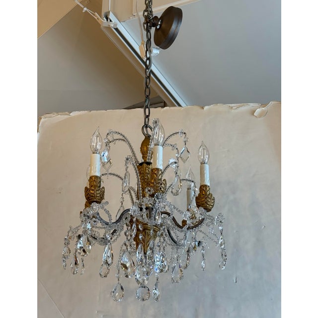 Design Plus Gallery presents a Petite Genovese Six-Light Chandelier by Eloquence. The carved wood center and leafy candle...