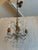 Design Plus Gallery presents a Petite Genovese Six-Light Chandelier by Eloquence. The carved wood center and leafy candle...