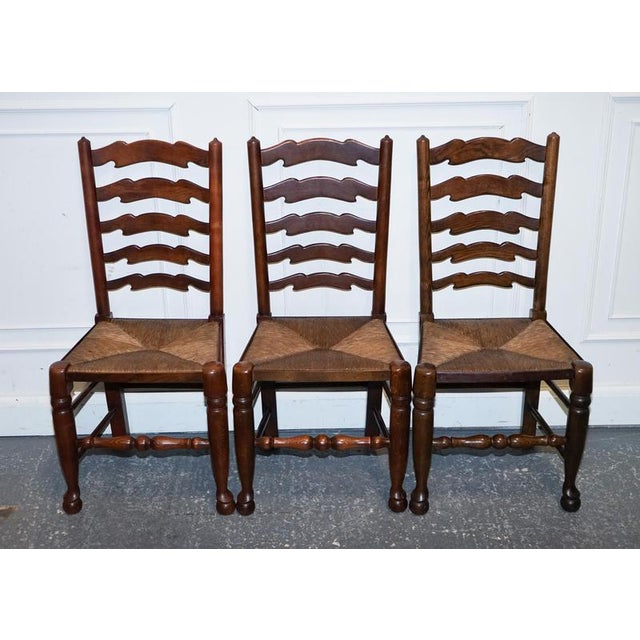Antiques of London A charming set of six English ladderback dining chairs, dating to circa 1910, full of honest country...