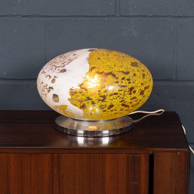 A striking murano art glass table lamp dating to the 1970s, crafted on the island of murano, italy. The lamp features an...