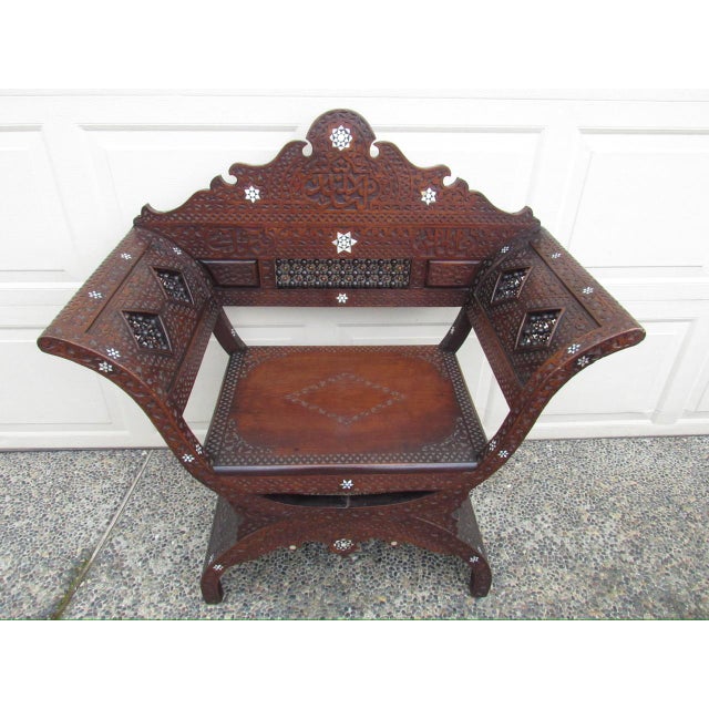 A good looking antique Moroccan inlaid chair, c.1900 Having a peaked back and sweeping curved arms and ample room for...