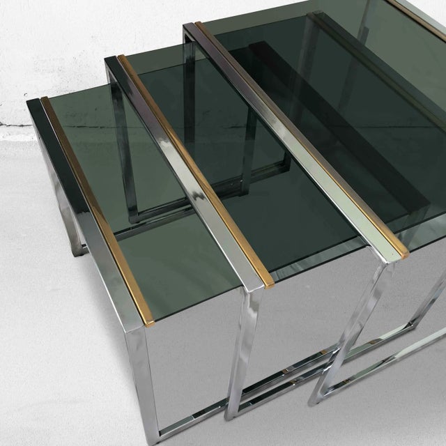 Vintage set of 3 nesting tables in chrome (silver/gold) and smoked glass. Because these mimi tables can be pushed...