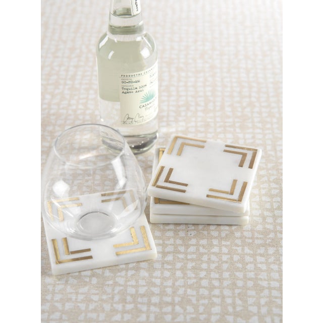 Protect your tabletops and table linens with these stylish marble coasters. These natural, white marble coasters with gold...