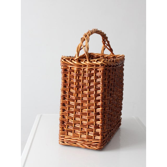 Warm honey-toned wicker and a timeless rectangular silhouette give this vintage market basket an effortless, collected...