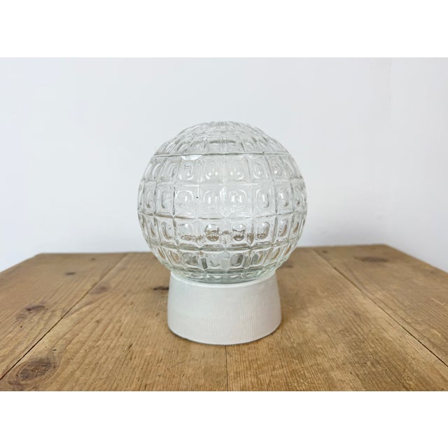 Vintage industrial ceiling or wall light made in former Czechoslivakia during the 1970s. It features a white porcelain...