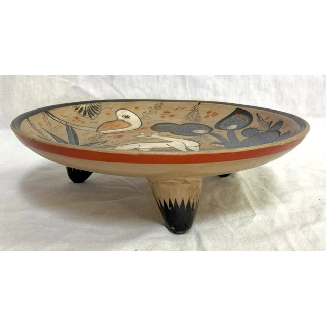 Intricately detailed vintage hand painted pottery decorative dish. The Folk Art decoration depicts animals and flowers in...