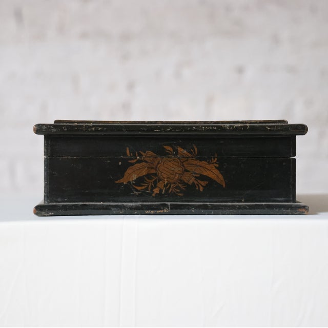 Early 19th-century French Chinoiserie box featuring a black lacquer finish with intricate gold detailing. This finely...
