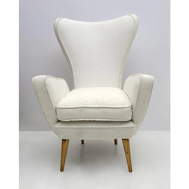 Emilio Sala and Giorgio Madini, armchair with tapered wooden legs, Italy, 1950s This delightful high-back armchair by...