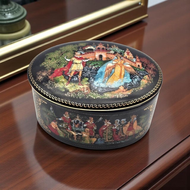 A finely detailed Soviet-era porcelain miniature box featuring a narrative scene from Pushkin’s The Tale of Tsar Saltan,...