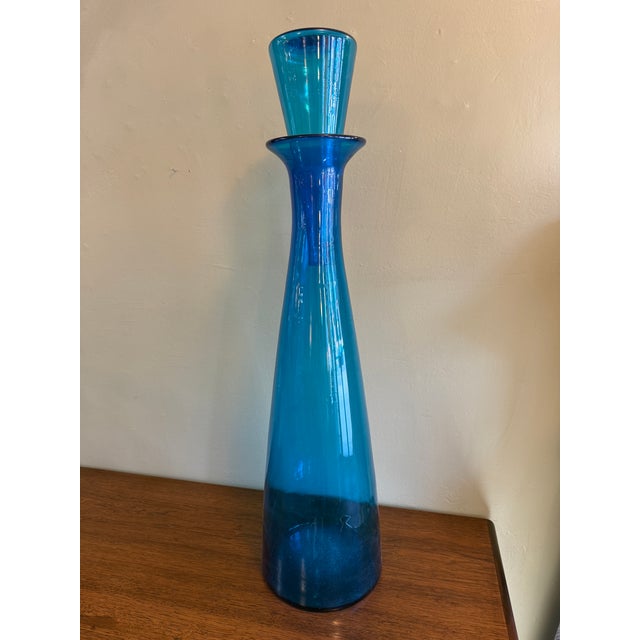 You are viewing a monumental Blue Glass Floor Decanter + Stopper by Wayne Husted for Blenko c1960s. The design features a...