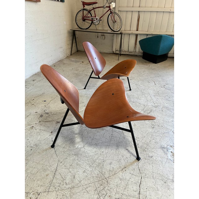 Modern sculpted lounge chairs called Kram chairs designed by Thomas Pedersen. Inspired by an open sea shell, these wide,...