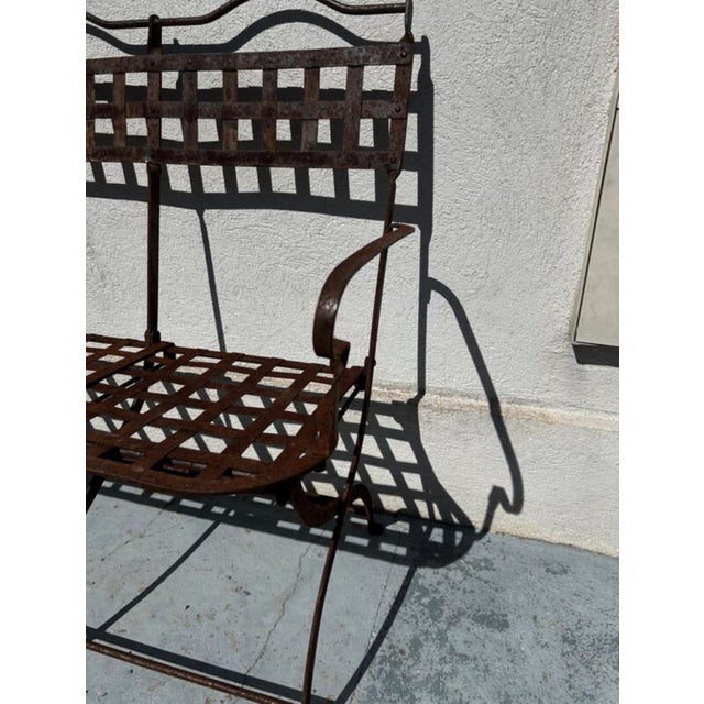 Authentic antique wrought iron garden bench with a beautiful openwork structure, fully preserved in its original patina....