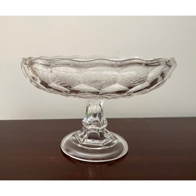 Antique crystal honeycomb pattern compote/comport has a scalloped edge and a pedestal base. It is 8" around and stands...