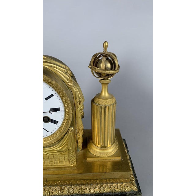 Empire or Directoire period clock, French work, circa 1800. Made of mercury-gilt bronze and polished with agate . It rests...