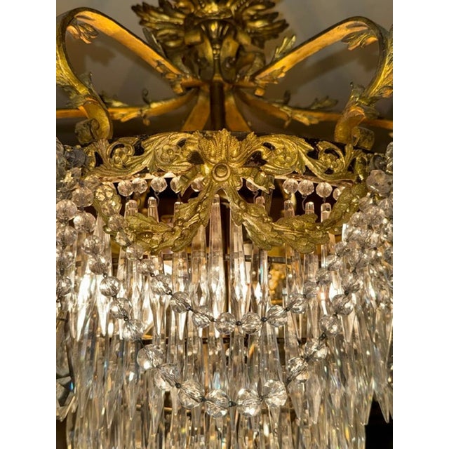 The 19th French Louis XV Gilt Bronze and Crystal Chandelier is a luxurious and elegant lighting fixture perfect for any...