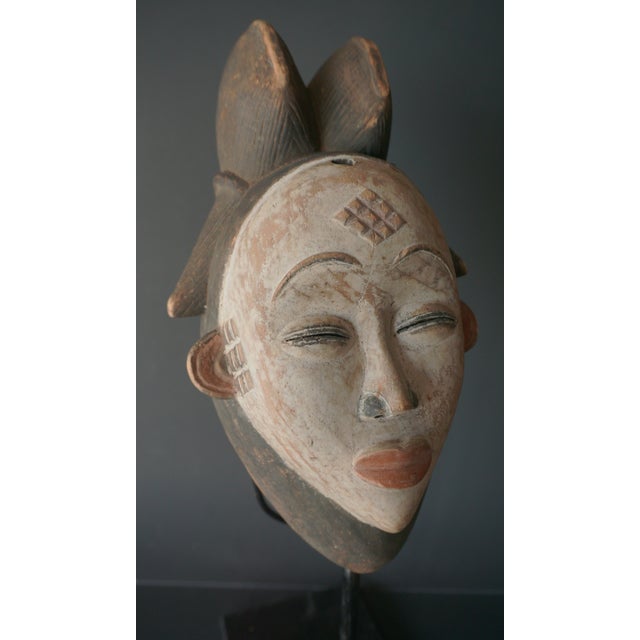 This is a Punu-Lumbo tribal mask native to the Ogooué River basin in Gabon, especially in the south in Ngounié Province....