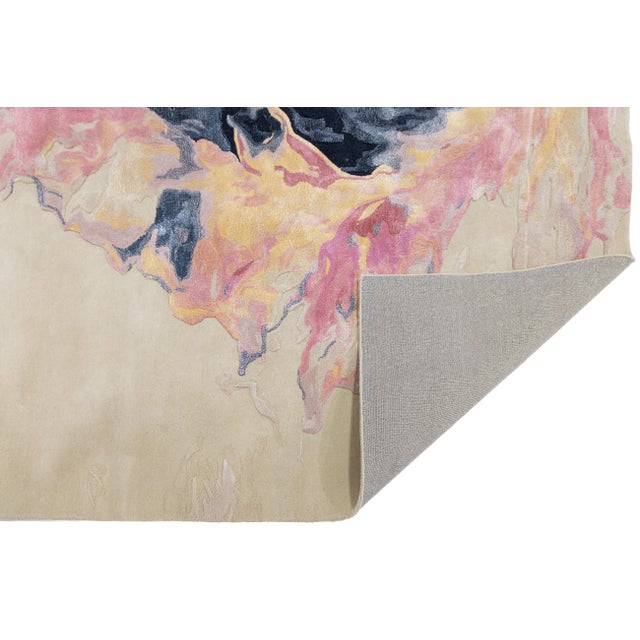 Elevate your space with this stunning hand-tufted rug, featuring a bold abstract design inspired by molten lava meeting...