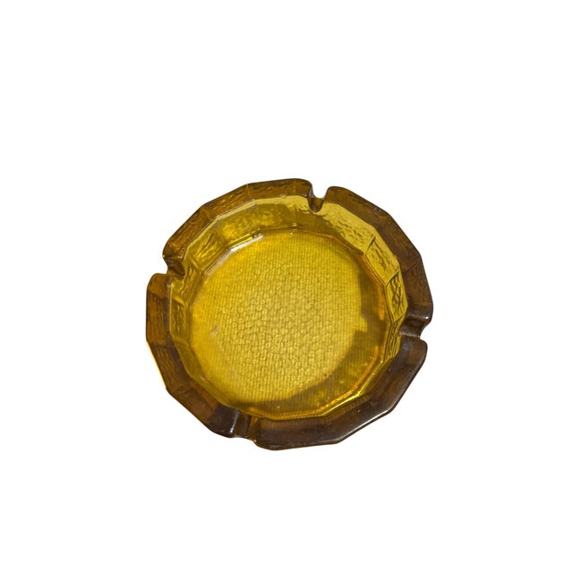 This vintage 1960’s -70’s Blenko Glass Co ash tray is made from heavy, honey amber art glass. It features a distinctive...