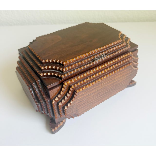 This wonderful American folk art box, an example of early 20th-century tramp art, includes an intricately chip-carved,...