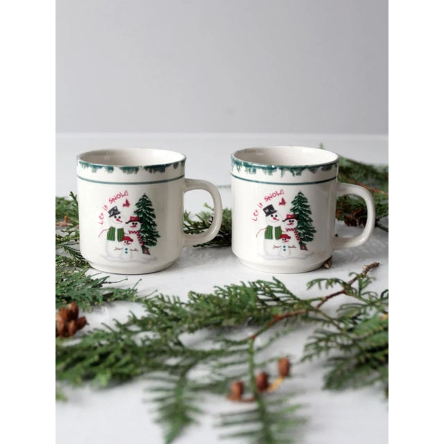 Add a touch of holiday cheer to your morning routine with this adorable set of two vintage "Let It Snow" snowman mugs....