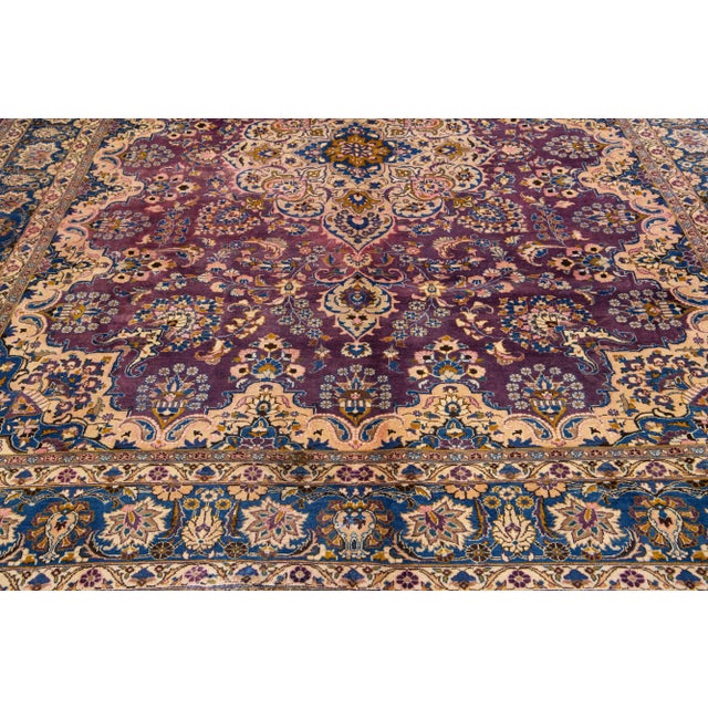 Beautiful vintage Persian Tabriz hand-knotted wool rug with a navy blue color field. This rug has a blue frame and...